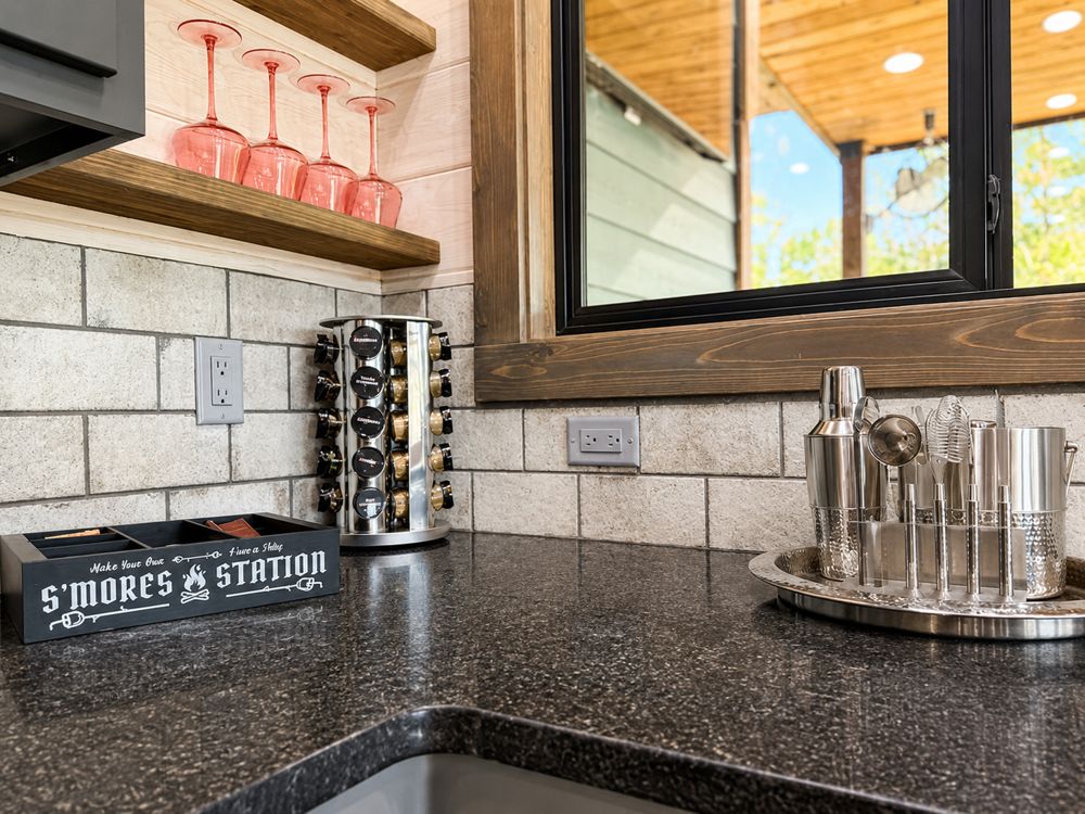 Bar and beverage station with a cocktail shaker and coupe glasses at a short-term rental