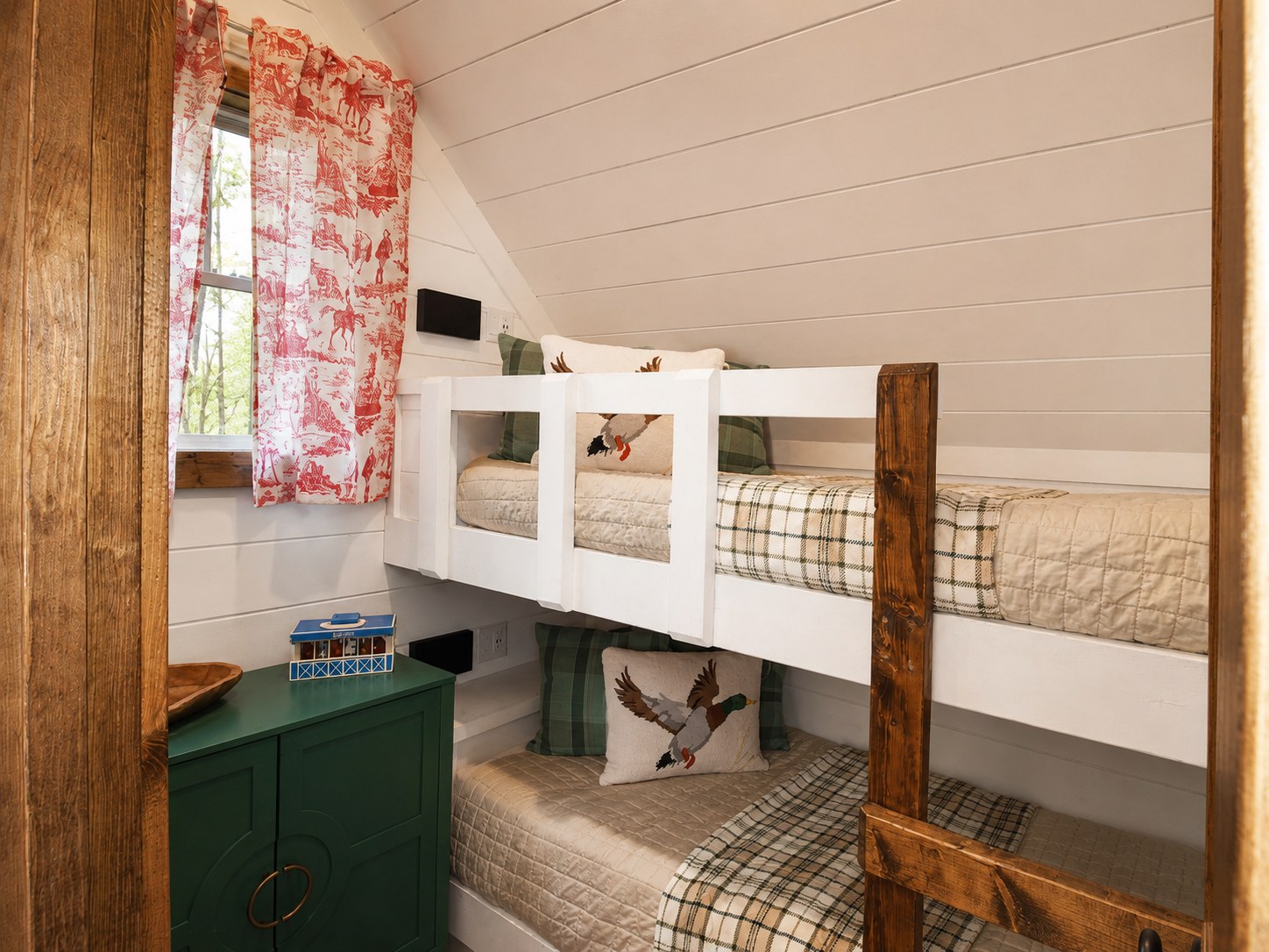 Gilded Spur kids bunk room after Yellowwood Atelier design, Hochatown OK equestrian-luxury vacation rental: custom cabin-style bunks, equestrian art panel, painted vanity, layered linens
