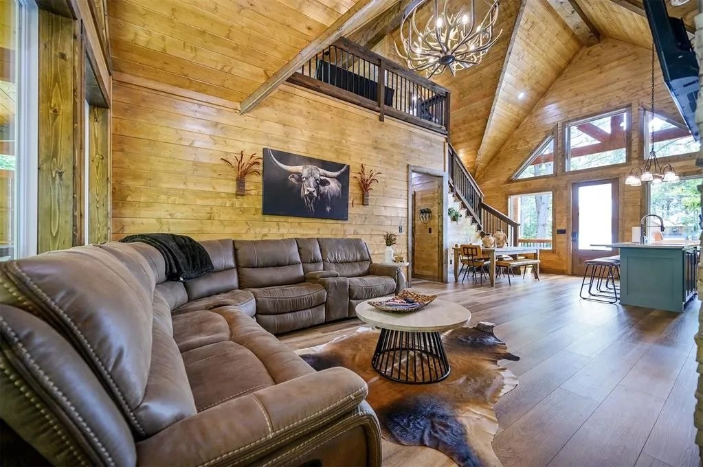 Gilded Spur great room before the mural was added, Broken Bow OK cabin: blank shiplap wall, generic leather sectional, no horse mural, no character