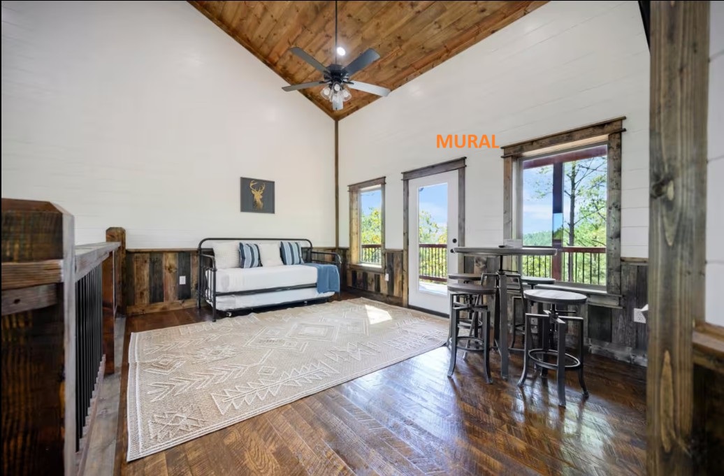 Generic loft space before — blank shiplap walls, daybed, generic Aztec rug