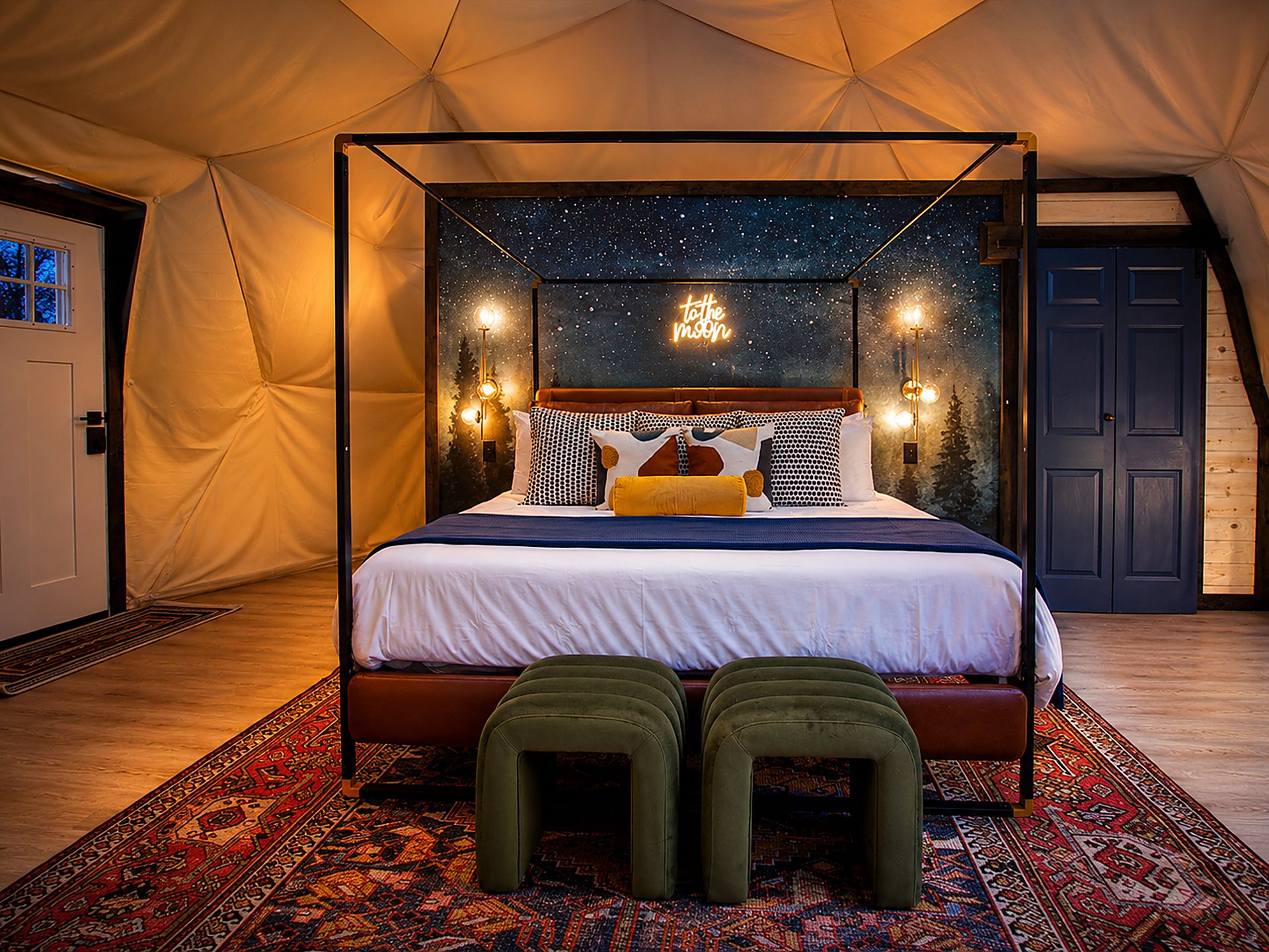 Geodesic dome bedroom with a star-mural canopy bed styled straight-on at Space Cowboy glamping rental in Hochatown, Oklahoma