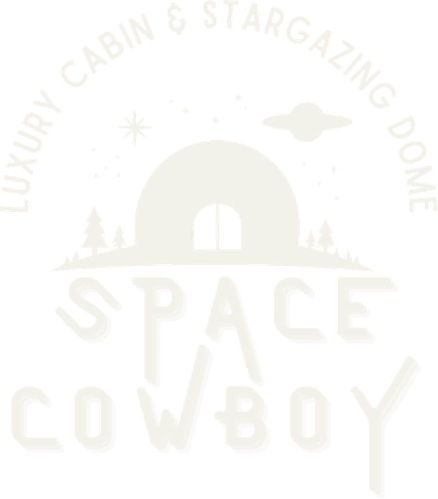The Space Cowboy wordmark in cream single-tone, over a firepit and string lights at dusk, Broken Bow Oklahoma stargazing dome